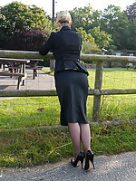 Sexy office girl Larissa takes a walk in the countryside after a day in the office still wearing her suit and shiny black high heels